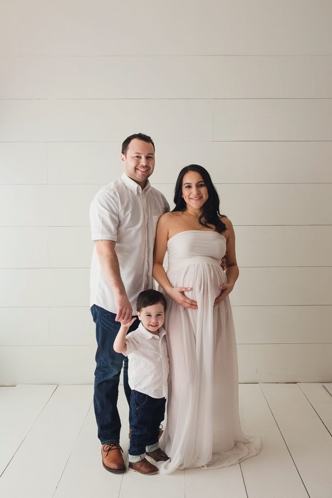 in-studio fine art portrait of family welcoming new baby